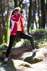 Woman with photo camera Taking photos in Woods