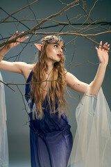 A young woman in a blue dress graciously holding a tree branch, embodying the essence of a fairy princess in a mystical setting.