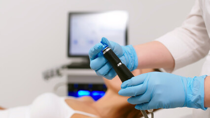 A female cosmetologist-dermatologist talks to a client sitting in a comfortable salon chair....