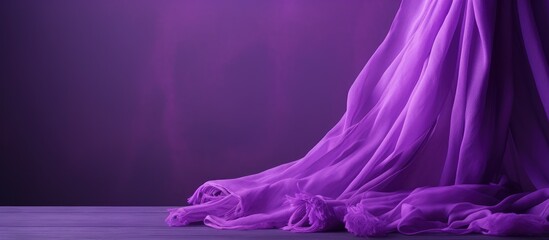 Purple fabric draped on wooden floor with a purple backdrop