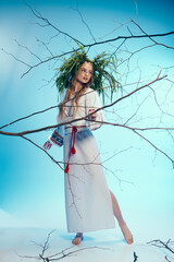 A young mavka in a white dress delicately holds a tree branch in a fantastical studio setting.