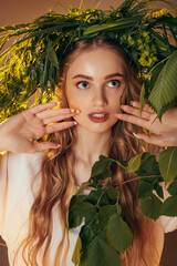 A young mavka embraces her connection to nature with long hair and a wreath on her head in a fairy and fantasy-inspired setting.