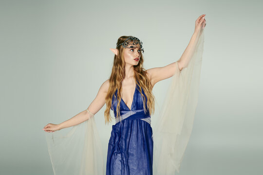 A young woman dressed in a flowing blue gown and delicate veil, embodying the essence of a mystical elf princess.