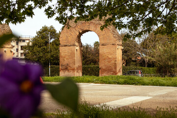 Fototapeta na wymiar Scorcio antico e arco dell'Acquedotto romano Alessandrino, nel parco di Tor Tre Teste a Roma, Italia