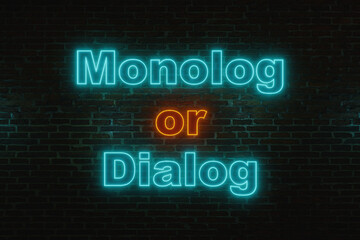 Monolog or dialog. Brick wall at night with the text 
