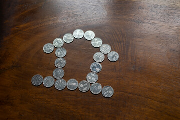 The coins are arranged to form a house