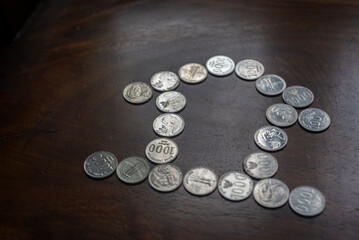 The coins are arranged to form a house