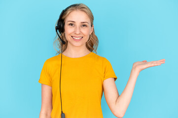 Woman in headset holding invisible offer on palm, provide client or customer support