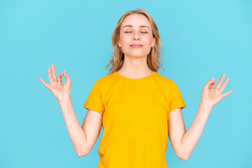 Young calm woman with closed eyes hold hands in mudra gesture - obrazy, fototapety, plakaty