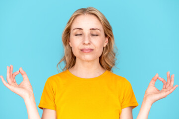 Satisfied woman doing meditation yoga gesture, trying to calm down