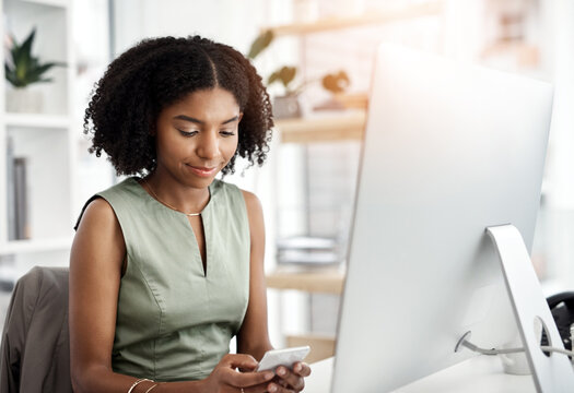 Black woman, computer and cellphone texting in office as copywriter for article brief, networking or proposal. Female person, smartphone and market research for seo report, connection or internet