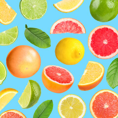 Many different fresh citrus fruits in air on light blue background