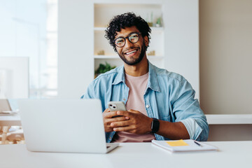Smiling young entrepreneur at modern office workspace