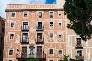 Fototapeta na wymiar Barcelona, Spain: House facades at Placa del Pi, a charming square located in the Gothic Quarter (Barri Gotic), named after the Church of Santa Maria del Pi