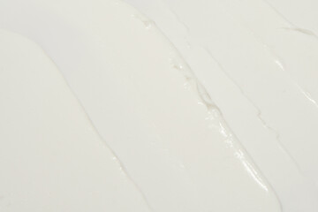 Thick white cosmetic cream applied to the surface. texture of the cream close-up.