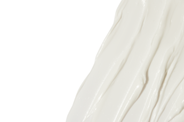 White cosmetic cream smeared on a blank background.
