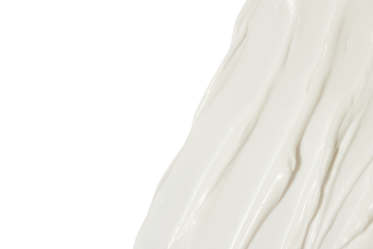 White cosmetic cream smeared on a blank background.
