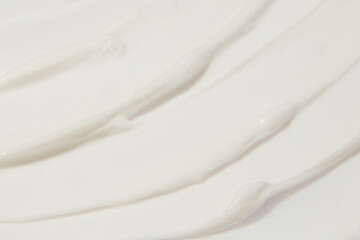 Thick white cosmetic cream applied to the surface. texture of the cream close-up.