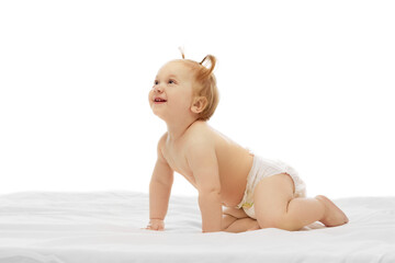 Curious little baby girl, child in diaper crawling, playing and smiling isolated on white background. World exploration. Concept of childhood, care, health, well-being, parenthood