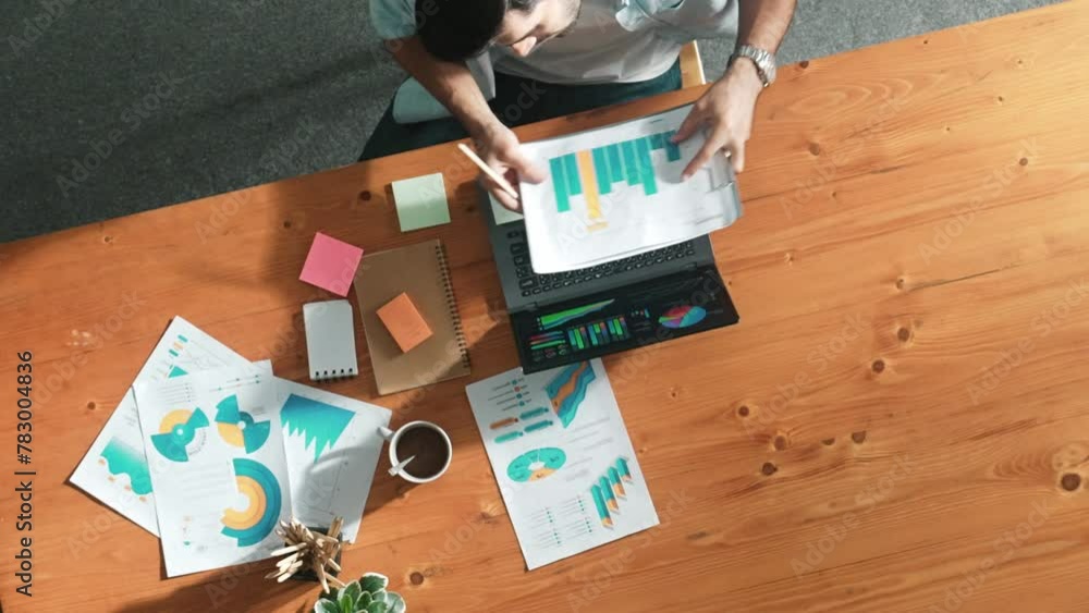 Poster top aerial view of manager working on laptop while looking at data analysis. leader compare financia