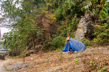 5th March, 2024, Jayanti river, Buxe tiger reserve, Alipur Duar, West Bengal, India: A devotee staying at temporary tented camp near Mahakaal cave at Buxa Jayanti on the ocation od Maha Shiv Ratri.