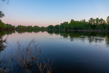 Fototapeta na wymiar Potamology. Great Don River in middle reaches. River in the evening hours before sunset. Coastal forest. Spring and high water
