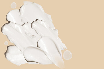 Fototapeta na wymiar smears of cosmetic cream on a beige background.