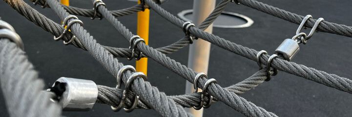 An abstract close-up of climbing rope equipment against a textured background, embodying strength...