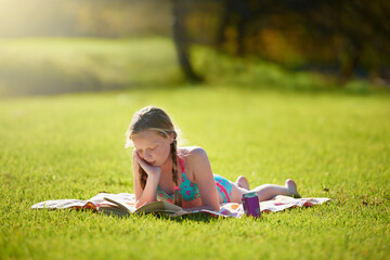 Girl, book or reading to relax, grass or imagine by story, freedom or vacation at summer camp....
