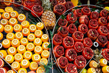 Fresh pomegranate and oranges at the Grand Bazaar, Istanbul. Flatlay view of orange, pomegranate, lemon, grapefruit filtered image