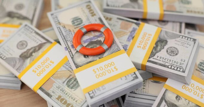 Lifebuoy and stacks of 100 bills concept