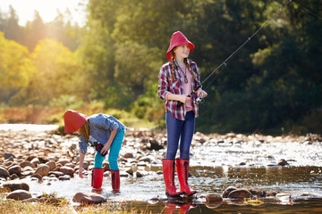 Countryside, children and fishing rod in river on holiday break, vacation or adventure as hobby....
