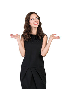A smiling woman in a black dress with her hands raised in a questioning gesture, isolated on a white background, depicting choice or uncertainty