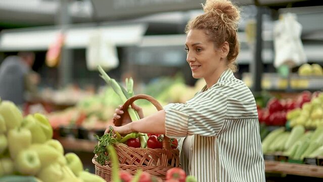 Female customer buying vegetables at marketplace.