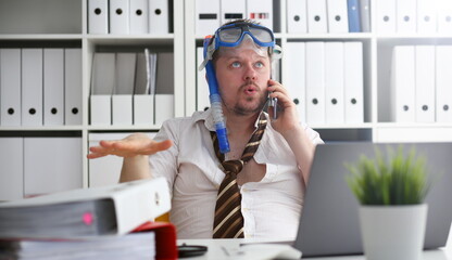 Man wearing suit and tie in goggles and snorkel talk cellphone at office workplace ready to take off portrait. Count days to leave annual day off workaholic freedom fun tourism resort idea concept