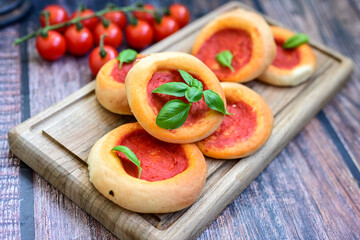 Mini margherita napoletan pizza with tomato,mozzarella  cheese and basil,  on wooden background