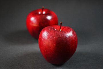 Ripe red apples closeup on a dark background