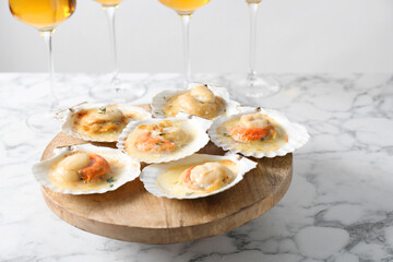 Fried scallops in shells on white marble table