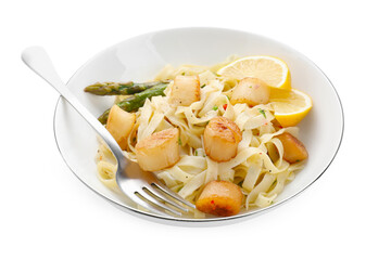 Delicious scallop pasta with asparagus, lemon and fork isolated on white