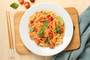 Vegetarian meal. Tasty pasta with fresh tomatoes and basil on wooden table, flat lay