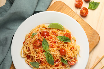 Vegetarian meal. Tasty pasta with fresh tomatoes and basil on wooden table, flat lay