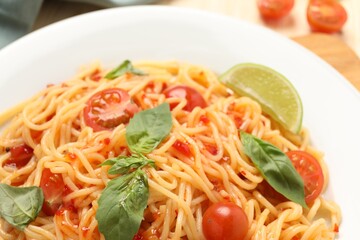 Vegetarian meal. Tasty pasta with fresh tomatoes and basil on plate, closeup
