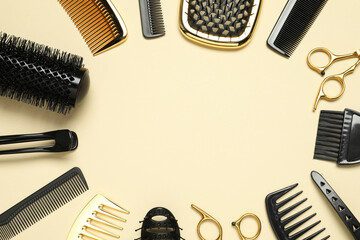 Frame of hairdressing tools on beige background, flat lay. Space for text