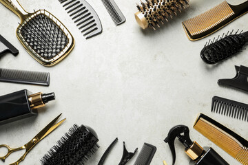Frame of hairdressing tools on light background, flat lay. Space for text