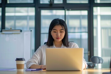 Bright office ambiance: Woman working with natural daylight