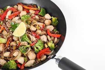 Stir-fry. Tasty noodles with meat and vegetables in wok on white background