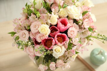 Beautiful bouquet of fresh flowers on table indoors, closeup