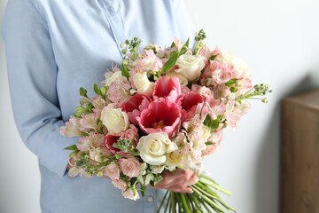 Woman with beautiful bouquet of fresh flowers indoors, closeup