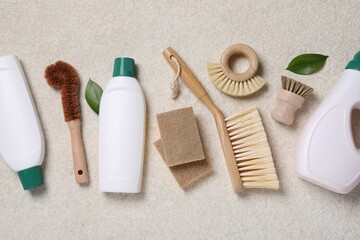 Flat lay composition with different cleaning supplies on beige background