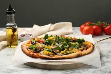 Delicious vegetarian pizza with mushrooms, vegetables and arugula on white marble table